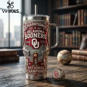 Oklahoma Sooners 2026 baseball championship tumbler with steel straw, 3D stadium graphic, and red enamel details on wood desk.!