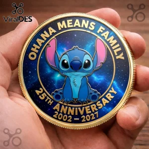 Gold-rimmed Stitch challenge coin with blue galaxy background and text reading Ohana Means Family 25th Anniversary 2002-2027.!