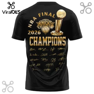 Black t-shirt featuring gold New York Knicks 2026 NBA Champions text, Larry O'Brien trophy graphic, and team signatures.!