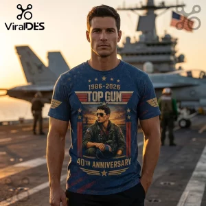 Man wearing a blue Top Gun 40th anniversary t-shirt featuring 1986-2026 text and pilot graphic on an aircraft carrier.!