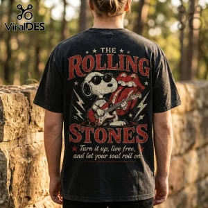 Vintage black acid-wash t-shirt featuring Snoopy playing guitar with Rolling Stones tongue logo and distressed text.!