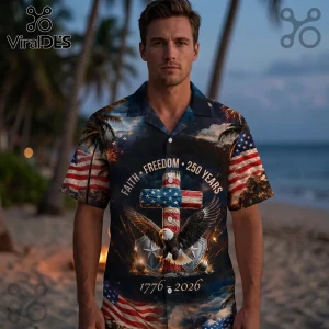 Man wearing a patriotic Hawaiian shirt with American flag cross, bald eagle, fireworks, and 1776-2026 text on a beach.!