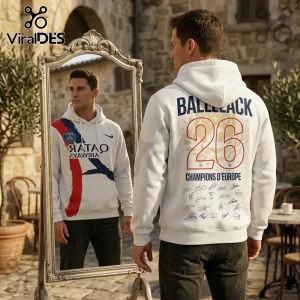 Man wearing a white hoodie with Paris Saint-Germain branding, BALLLACK 26 text, and player signatures on the back.!