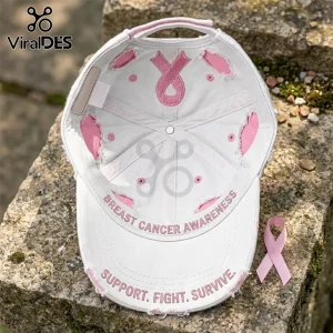 Distressed white baseball cap featuring pink embroidery of a breast cancer ribbon and text Support, Fight, Survive.!