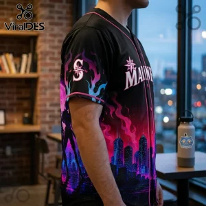 Black baseball jersey with pink and blue city skyline, fire graphics, and Seattle Mariners logo on chest and sleeve.!