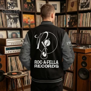 Black and grey Roc-A-Fella Records varsity jacket with logo and tracklist text on sleeves in a vinyl record shop interior.!