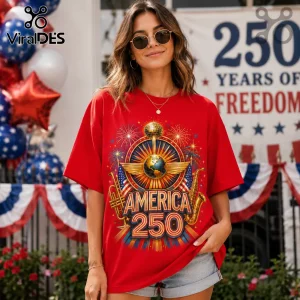 Woman wearing red t-shirt with America 250 graphic featuring globe, musical instruments, fireworks, and disco ball design.!