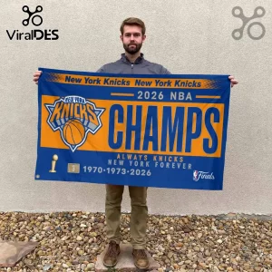 Man holding a blue and orange New York Knicks 2026 NBA Champions wall banner with championship years listed at the bottom.!