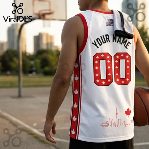 Custom white basketball jersey with red maple leaf patterns on sides, red number 00, and Toronto skyline graphic.!
