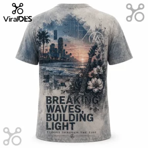 Gray t-shirt featuring a city skyline, beach, guitar, and floral art with text reading Breaking Waves, Building Light.!