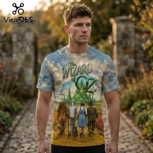 Man wearing a crew neck t-shirt featuring The Wizard of Oz graphic with Emerald City, yellow brick road, and characters.!