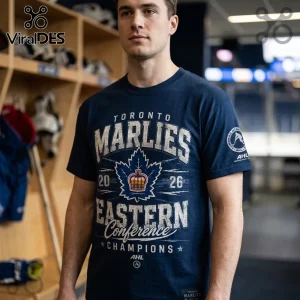 Man wearing a navy Toronto Marlies 2026 Eastern Conference Champions graphic t-shirt with a hockey locker room background.!