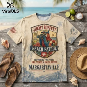 Jimmy Buffett Beach Patrol graphic t-shirt with a parrot wearing binoculars, hibiscus, and nautical emblems on tan fabric.!