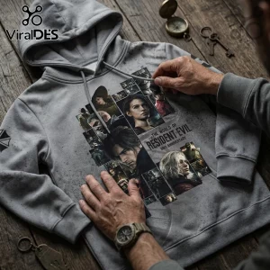 Gray cotton hoodie featuring a Resident Evil 30th anniversary graphic collage of characters on a wooden table.!
