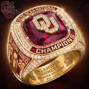 Oklahoma Sooners 2026 NCAA championship gold ring with large red center stone, embedded diamonds, and team inscriptions.!