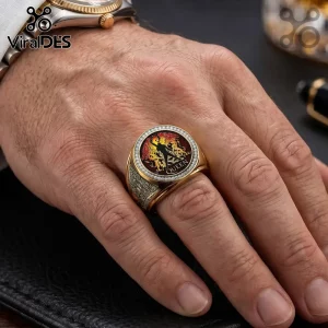 Gold Queen band ring featuring the Freddie Mercury silhouette crest, surrounded by small crystals on a hand.!