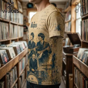 Beige crew neck t-shirt featuring The Beatles band members, sheet music, and song titles in a vintage ink wash print.!