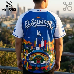 Blue and white Los Angeles Dodgers baseball jersey with El Salvador text, stadium graphic, and city skyline print.!