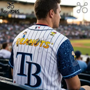 Tampa Bay Rays baseball jersey featuring Peanuts characters, white pinstripes, blue sleeves, and text reading PEANUTS.!