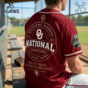 Maroon Oklahoma Sooners baseball jersey featuring National Champions text, 2026 branding, and NCAA World Series sleeve patch.!