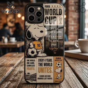 iPhone case featuring Snoopy in a yellow soccer jersey with a ball, FIFA World Cup branding, and inspirational text.!