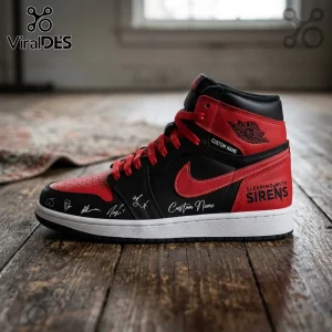 Custom Sleeping With Sirens high-top sneaker in black and red leather with white soles and signatures on a wood floor.!
