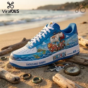 One Piece custom sneaker featuring the Thousand Sunny ship, blue ocean graphics, white laces, and logo on sandy beach.!