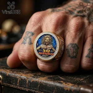Gold Iron Maiden 50th anniversary ring with Eddie graphic, blue lightning background, and crystal-encrusted bezel.!