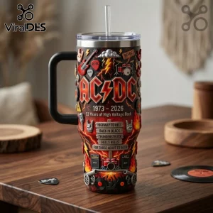AC/DC themed 3D-effect stainless steel tumbler with handle, straw, guitar, drum, and song title graphics on a wooden table.!