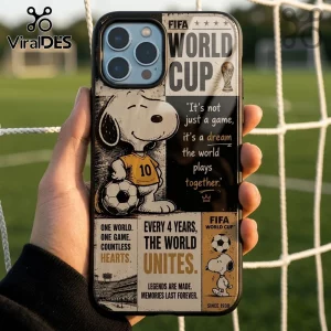 iPhone case featuring Snoopy in a soccer jersey, FIFA World Cup branding, and inspirational text against a soccer net.!