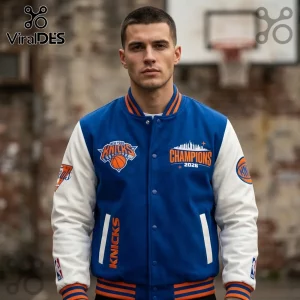 Man wearing a blue and white New York Knicks 2026 Champions varsity jacket with orange embroidery and basketball patches.!