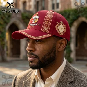 Maroon Kappa Alpha Psi baseball cap featuring gold embroidery, the crest, and K A Psi greek letters on a blurred campus.!