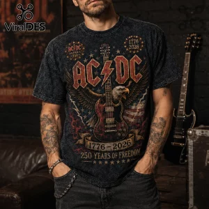 AC/DC graphic t-shirt featuring an American eagle, electric guitar, and 1776-2026 text on a charcoal acid-wash fabric.!