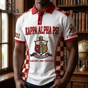 Kappa Alpha Psi white polo shirt with red collar, crest, and checkerboard side panels, featuring fraternity lettering.!