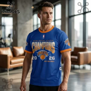 Man wearing a blue New York Knicks 2026 NBA Champions t-shirt with orange trim, featuring basketball graphics and team text.!