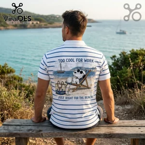 Man wearing a white polo shirt with blue stripes and a Snoopy beach graphic with text Too Cool For Work.!