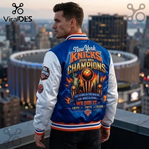 Man wearing blue and white New York Knicks 2026 NBA Champions satin varsity jacket with championship trophy graphic back.!