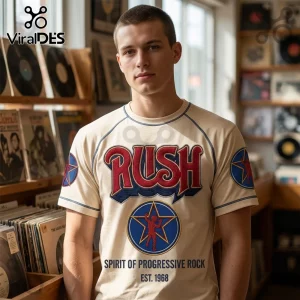 Man wearing a cream-colored t-shirt with red and blue Rush band logo, star emblem, and text Spirit of Progressive Rock.!