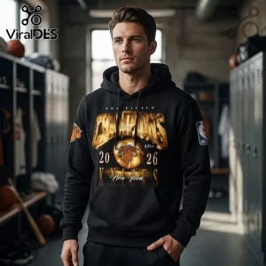 Man wearing a black cotton hoodie with gold New York Knicks 2026 NBA Finals Champions graphic in a locker room setting.!
