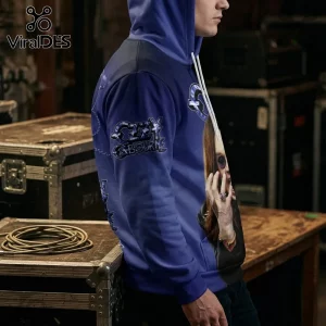 Man wearing a blue Ozzy Osbourne hooded sweatshirt with graphic print, white drawstrings, and metal hardware background.!