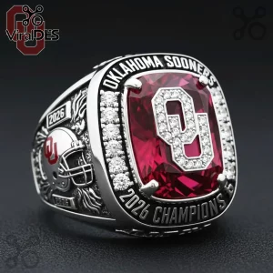 Oklahoma Sooners 2026 championship ring featuring a large red center stone, OU logo, diamonds, and a silver helmet design.!