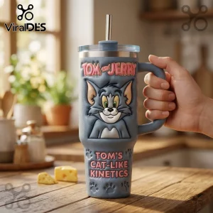 Grey Tom and Jerry insulated tumbler with 3D embossed character relief, steel straw, and paw print details on wood table.!