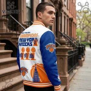 New York Knicks varsity jacket featuring orange and blue graphics, 1970-1973-2026 championship trophies, and a city skyline.!