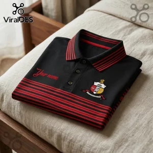 Black polo shirt with red horizontal stripes on chest and collar, featuring a crest emblem and customizable text area.!