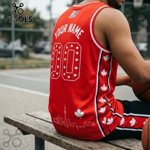 Custom red basketball jersey featuring white maple leaf patterns, Toronto skyline graphic, and player number 00 on back.!