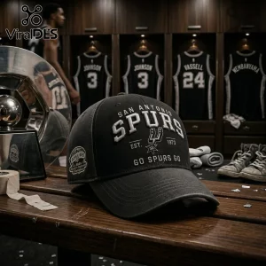 San Antonio Spurs black baseball cap with white embroidered text and logo resting on a wooden locker room bench.!