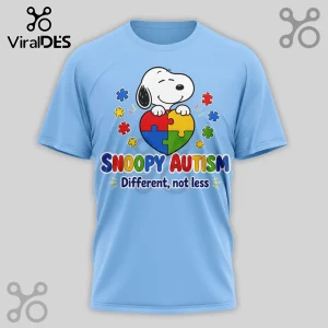 Light blue crew neck t-shirt featuring Snoopy holding a multi-colored puzzle piece heart with text Snoopy Autism.!