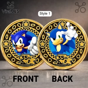Two gold-colored Sonic the Hedgehog 35th Anniversary commemorative coins featuring blue enamel character art on grey table.!