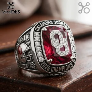 Oklahoma Sooners 2026 championship ring with a large red center stone, silver metal, and football helmet side detail.!