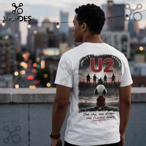 White crewneck t-shirt featuring a back graphic of Snoopy watching a U2 concert with text one sky one dream one heart.!
